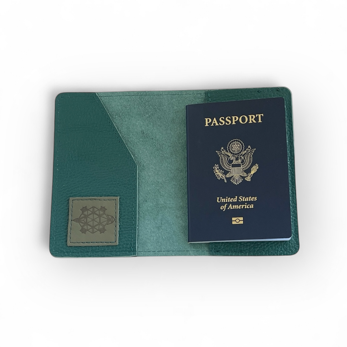 Green leather passport holder with a United States passport inside on a white background