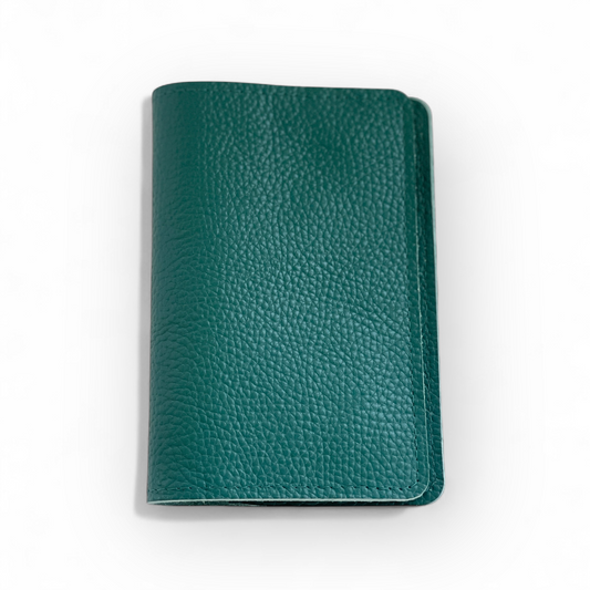 Green leather passport holder on a white background